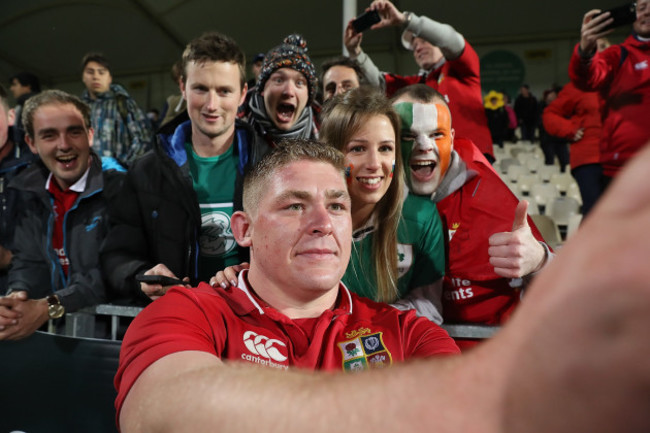 Tadhg Furlong poses for a selfie with fans after the game