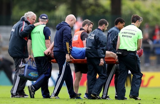 Michael Quinlivan is carried off after receiving an injury from falling awkwardly