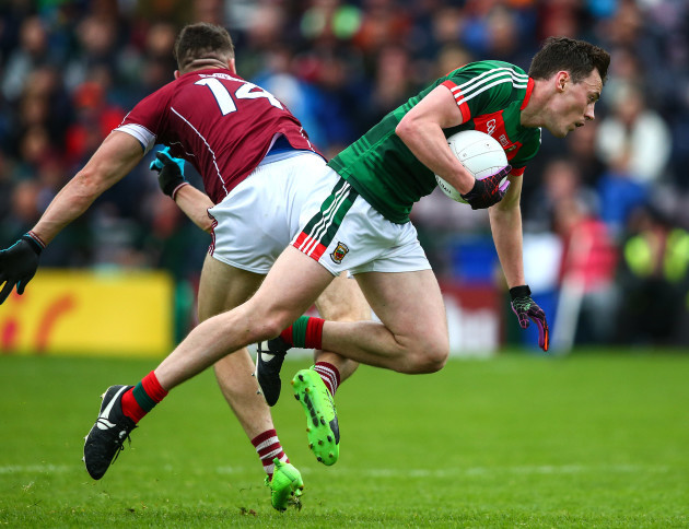 Damien Comer with a shoulder tackle on Diarmuid O'Connor