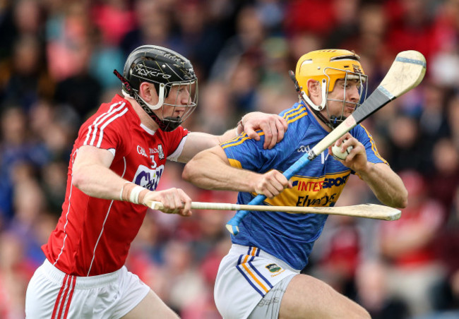 Seamus Callanan is tackled by Damian Cahalane