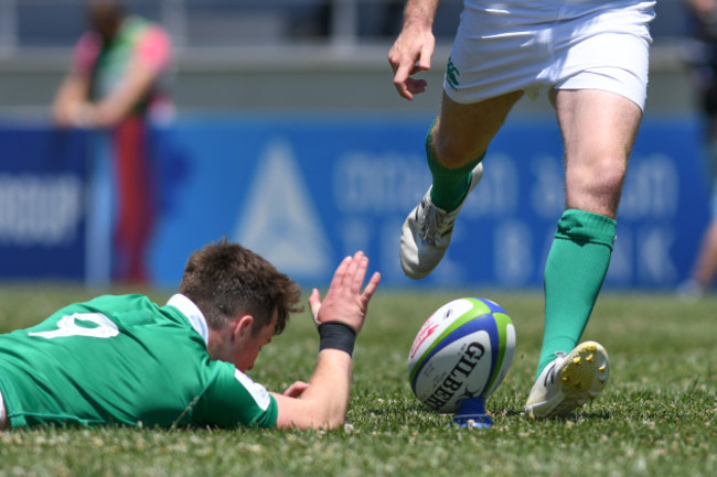 Jack Stafford holds the ball as Conor Dean kicks