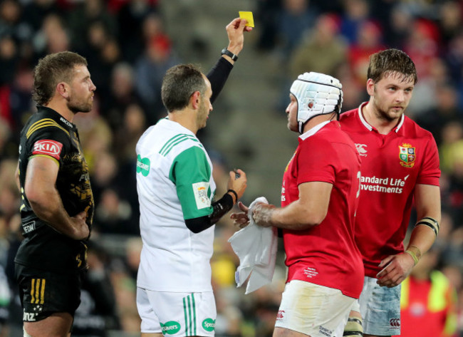 Romain Poite shows a yellow card to Iain Henderson