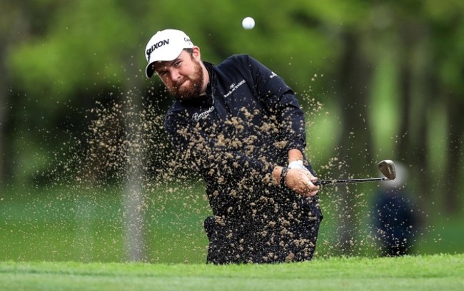 Shane Lowry plays his way out of a bunker on the fourth hole