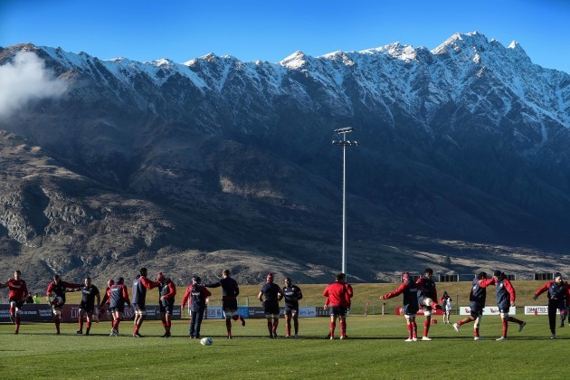 British and Irish Lions team warm up in  front of the The Remarkables mountains in Queenstown