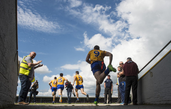 The Clare team run onto the pitch