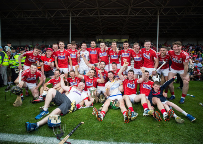 Cork players celebrate with the cup after the match