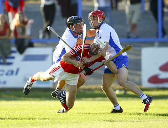 Tim O&Otilde;Mahony is tackled by Conor Gleeson and Darragh Lyons