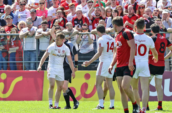 Kieran McGeary is shown a black card by referee Joe McQuillan