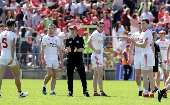 Mickey Harte calls his players in to talk on the pitch before heading in to the dressing rooms at half time