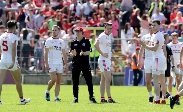 Mickey Harte calls his players in to talk on the pitch before heading in to the dressing rooms at half time