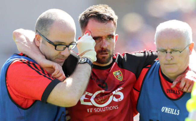 Mark Poland leaves the pitch with an injury