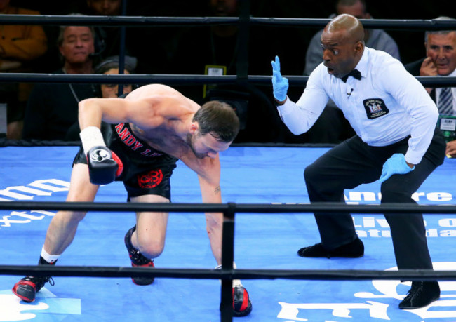 The referee counts down Andy Lee after he was knocked down in the first round