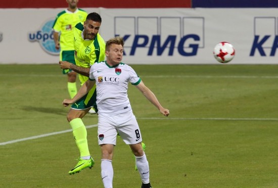 Florian Taulemesse wins a header over Conor McCormack