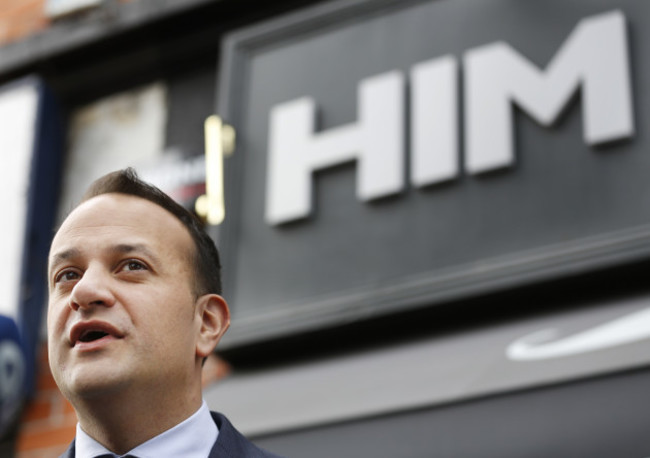 Pictured is Minister Leo Varadkar standing under a sign that says HIM