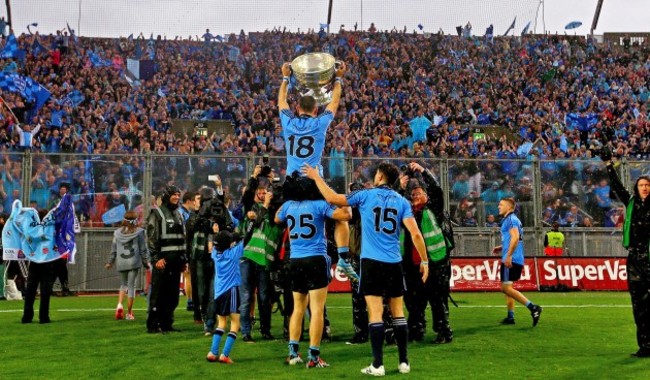 Alan Brogan celebrates with the Sam Maguire trophy in front of Hill 16