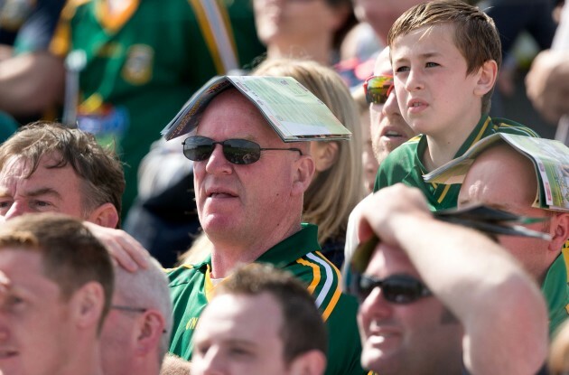 Fans shelter from the sunshine