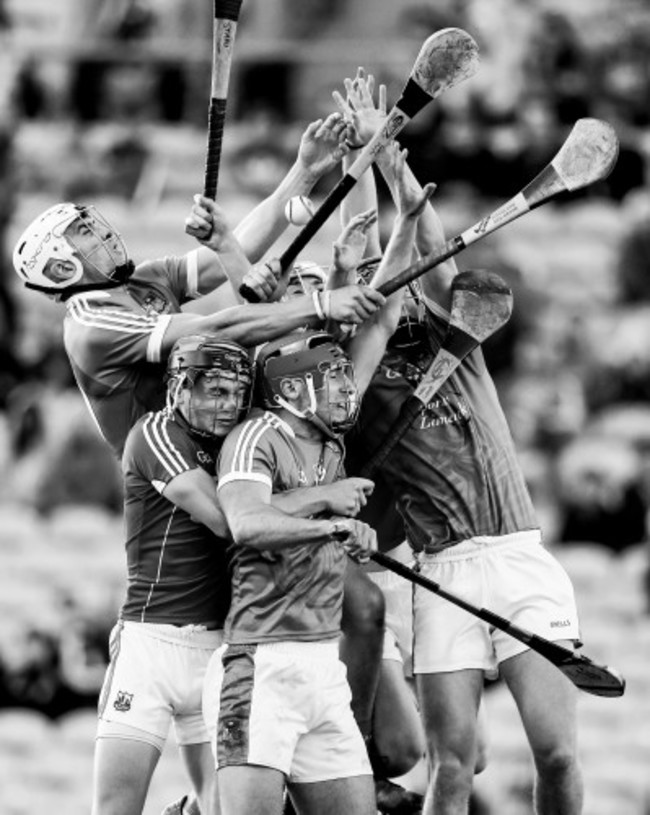 Limerick and cork players compete for the ball