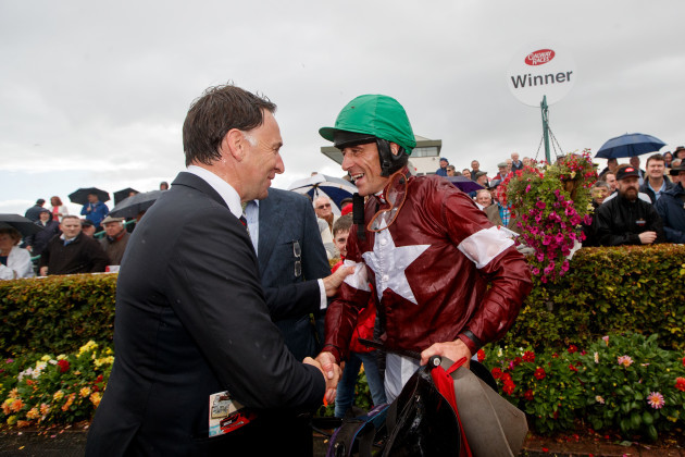 Davy Russell celebrates with his trainer Henry de Bromhead after he won with Balko Des Flos
