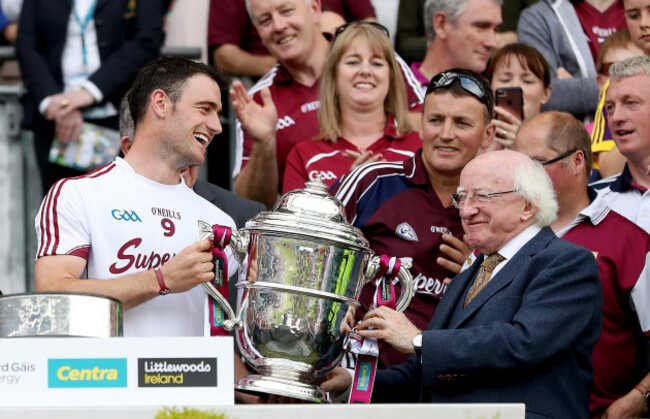 David Burke lifts the Bob O'Keeffe Cup with Michael D Higgins