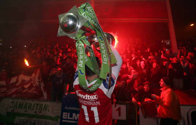 Killian Brennan holds the trophy up in front of Pat's supporters