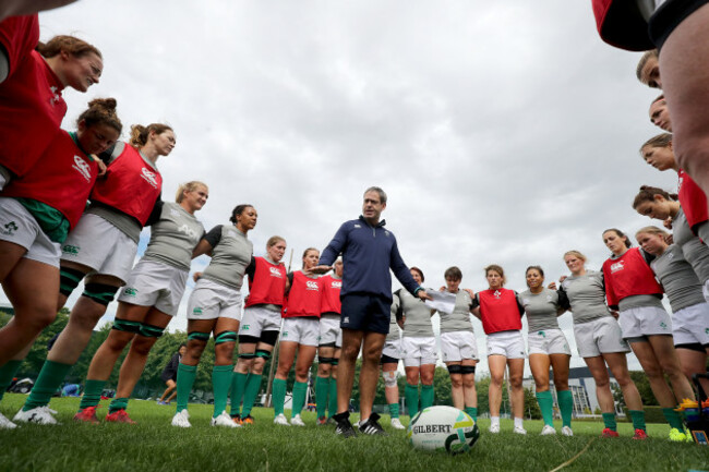 Tom Tierney talks to his team in the huddle