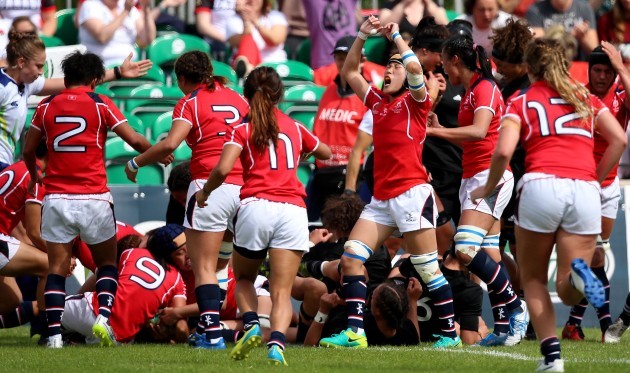 Hong Kong celebrate holding up the ball on the try line