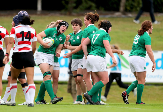 Paula Fitzpatrick celebrates her try with teammates
