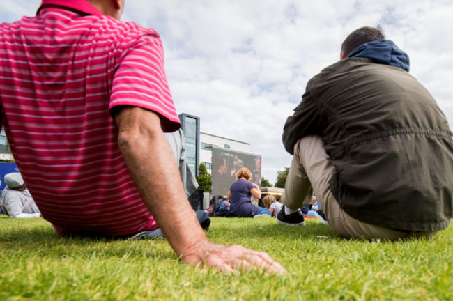 Fans watch the match in the Fanzone