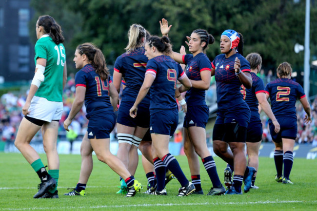 Romane Menager celebrates scoring a try with teammates