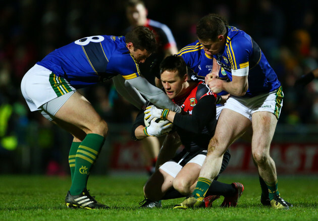 David Moran, Mark Griffin and Tadhg Morley tackle Andy Moran