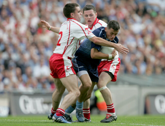 Alan Brogan with Conor Gormley and Ryan McMenamin