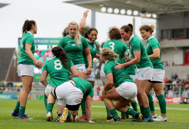 Ailis Egan celebrates scoring their first try with Nora Stapleton and Sene Naoupu