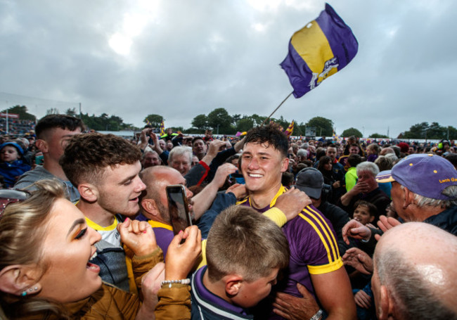 Lee Chin celebrates with fans