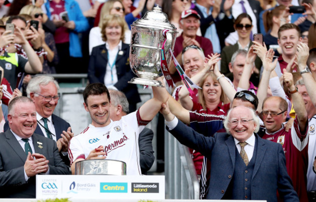 David Burke lifts the Bob O'Keeffe Cup with Michael D Higgins