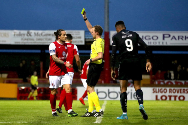 Rhys McCabe is shown a yellow card by referee Keith Kennedy