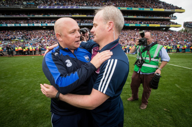 Derek McGrath and Michael Donoghue embrace after the game