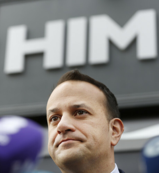 Pictured is Minister Leo Varadkar standing under a sign that says HIM