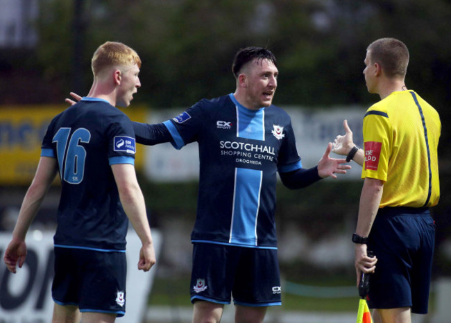 Aaron Molloy and Sean Brennan dispute the penalty with the referee's assistant