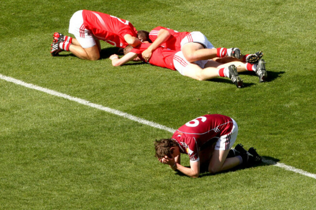 Thomas Flynn lies dejected as Jamie Wall, Jamie Burns and Luke O'Connolly celebrate