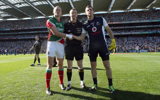 Andy Moran and Stephen Cluxton with referee Joe McQuillan