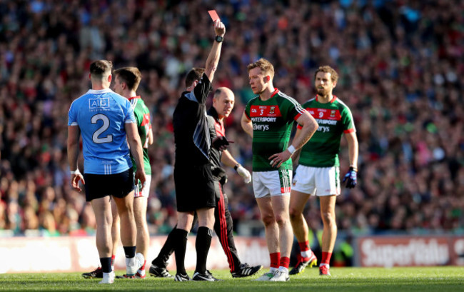 Donal Vaughan receives a red card from referee Joe McQuillan after a strike on John Small