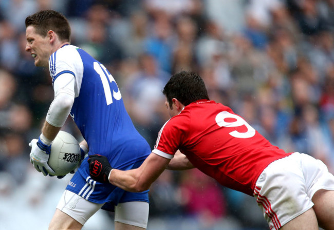 Conor McManus is dragged down by Sean Cavanagh