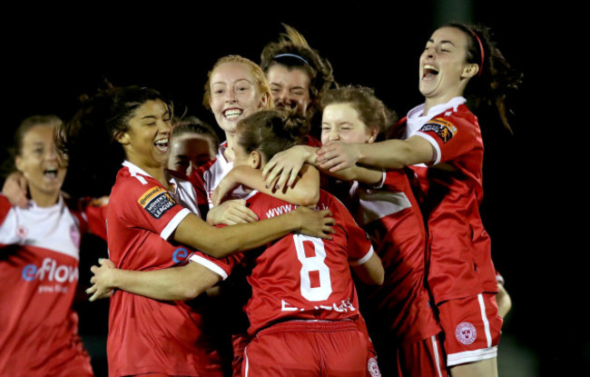 Rachal Graham is mobbed by her teammates after scoring the winning penalty