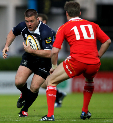 John Fogarty runs at Ronan O'Gara