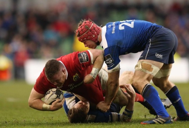 Munster’s Dave Kilcoyne is tackled by Leinster’s Garry Ringrose and  Josh Van der Flier