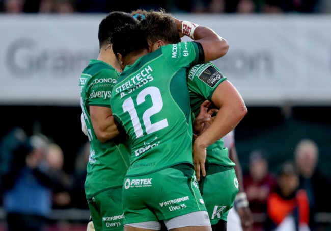 Tom Farrell celebrates with Bundee Aki and Tiernan O’Halloran