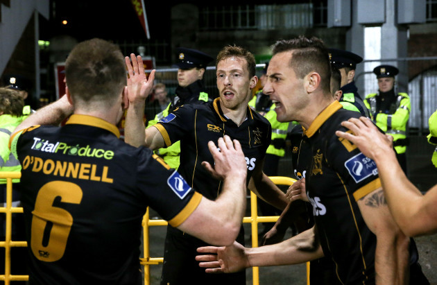 David McMillan celebrates scoring a goal with Stephen O'Donnell and Dylan Connolly