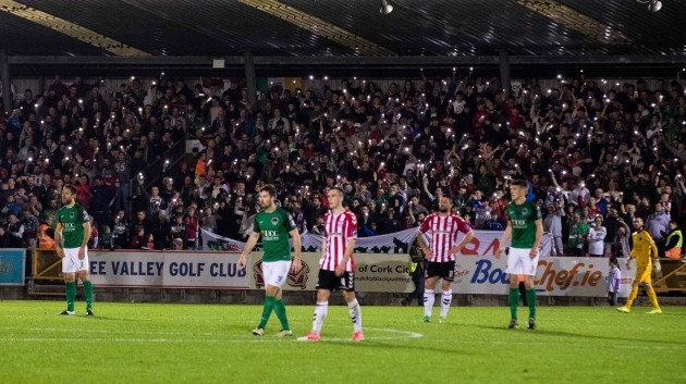Cork City fans hold lights during the game