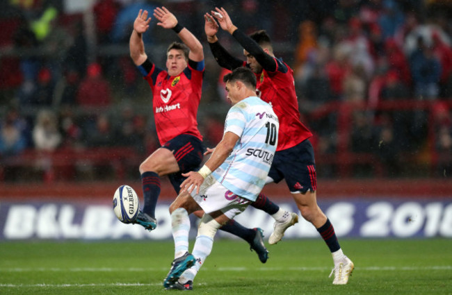 Dan Carter kicks as Ian Keatley and Conor Murray attempt to block down