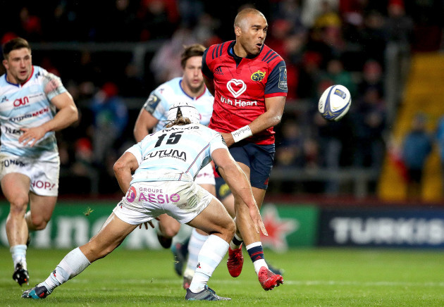Simon Zebo offloads under pressure from Pat Lambie